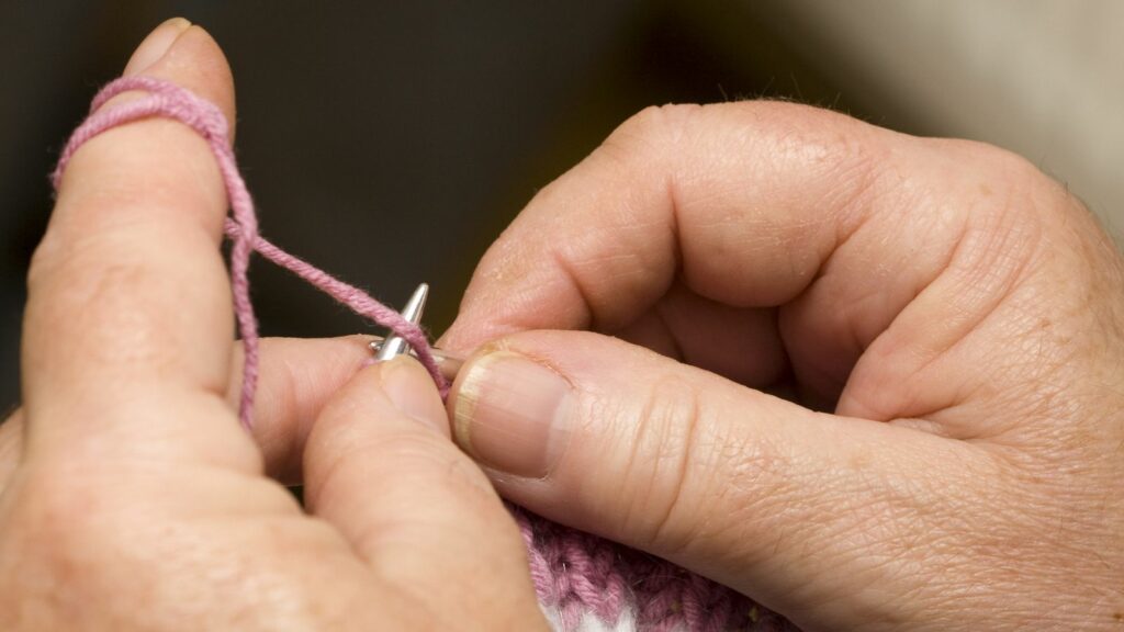 close up of a person knitting for stimulation therapy