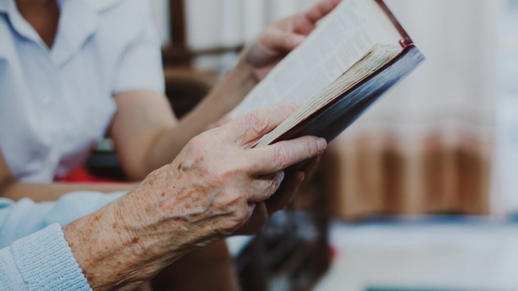 elderly woman reading a book